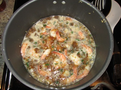 A pot with seasoned beer and shrimp, cooked and bubbling